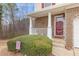 Charming front entrance with brick detail and a cozy porch with classic white pillars at 144 Fox Creek Dr, Woodstock, GA 30188