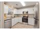 Well-lit kitchen featuring white cabinets, stainless steel appliances, and stylish granite countertops at 144 Fox Creek Dr, Woodstock, GA 30188