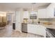 Modern kitchen featuring white cabinets, stainless appliances, and granite countertops at 144 Fox Creek Dr, Woodstock, GA 30188