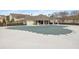 A community pool is covered for the off-season, with a patio and seating visible behind an iron fence at 144 Fox Creek Dr, Woodstock, GA 30188