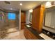 Well-lit bathroom with double vanity, tiled shower, and ample cabinet space at 2690 Twin Creek Ct, Marietta, GA 30062