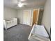 Bedroom with carpet, ceiling fan, closet, and changing table at 2690 Twin Creek Ct, Marietta, GA 30062