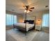 Bedroom with a four poster bed, modern fan, and bright lighting at 2690 Twin Creek Ct, Marietta, GA 30062