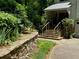 Stone steps lead to the covered front porch, surrounded by lush landscaping and greenery at 2690 Twin Creek Ct, Marietta, GA 30062