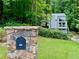 Charming exterior with stone mailbox, lush lawn, and mature trees at 2690 Twin Creek Ct, Marietta, GA 30062