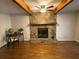 Living room with stone fireplace, hardwood floors, and wood beams at 2690 Twin Creek Ct, Marietta, GA 30062