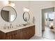 Bathroom showcasing dual sinks, modern lighting, and a view into an adjacent bedroom at 675 Drewry Ne St # 602, Atlanta, GA 30306