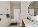 Bright bathroom features a shower-tub combo, modern vanity, round mirror and neutral design at 675 Drewry Ne St # 602, Atlanta, GA 30306