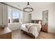 Bedroom with a neutral palette, a chandelier, and large windows showcasing city views at 675 Drewry Ne St # 602, Atlanta, GA 30306