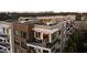 Close up of a multi-story apartment building with rooftop deck featuring outdoor furniture at 675 Drewry Ne St # 602, Atlanta, GA 30306