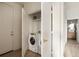 Hallway including laundry closet with a washer and dryer unit at 675 Drewry Ne St # 602, Atlanta, GA 30306