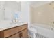 Elegant bathroom showcasing a wood vanity, modern fixtures, and a bathtub with decorative tile accents at 2018 Stonecreek Dr, Woodstock, GA 30188