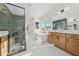 Bright bathroom with dual vanities, soaking tub, and frameless glass shower with tiled walls and floor at 2018 Stonecreek Dr, Woodstock, GA 30188