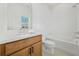Bathroom featuring a light wood vanity, neutral paint, and a combination tub and shower at 2018 Stonecreek Dr, Woodstock, GA 30188