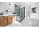 Bright bathroom with dual vanities, soaking tub, and frameless glass shower with tiled walls and floor at 2018 Stonecreek Dr, Woodstock, GA 30188