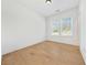 Unfurnished bedroom with hardwood floors, white walls and trim, and a window with blinds at 2018 Stonecreek Dr, Woodstock, GA 30188