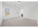 Spacious bedroom with two large windows offering ample natural light and neutral walls, carpet, and trim at 2018 Stonecreek Dr, Woodstock, GA 30188