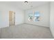 Bedroom with an en-suite bathroom, neutral paint, and an oversized window at 2018 Stonecreek Dr, Woodstock, GA 30188