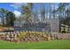 Stone community sign for Holly Farm, surrounded by landscaping and lush green grass at 2018 Stonecreek Dr, Woodstock, GA 30188