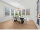Sun-filled dining room offers bright windows, hardwood floors, and an elegant chandelier at 2018 Stonecreek Dr, Woodstock, GA 30188