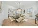 Elegant dining room with hardwood floors, modern chandelier, and large windows at 2018 Stonecreek Dr, Woodstock, GA 30188