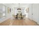 Elegant dining room with hardwood floors, modern chandelier, and large windows at 2018 Stonecreek Dr, Woodstock, GA 30188