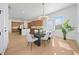 Bright dining room with modern lighting, a large table, and an open view to the kitchen at 2018 Stonecreek Dr, Woodstock, GA 30188