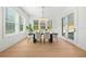 The brightly-lit dining area features large windows, a modern light fixture, and views of the exterior at 2018 Stonecreek Dr, Woodstock, GA 30188