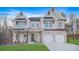 Charming two-story home with a white brick exterior, two-car garage, and a well-manicured front yard at 2018 Stonecreek Dr, Woodstock, GA 30188