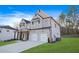 Beautiful two-story home with brick and siding, a two-car garage, and a well-maintained front yard at 2018 Stonecreek Dr, Woodstock, GA 30188