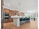Open concept kitchen with a center island and breakfast bar next to a dining area with natural light at 2018 Stonecreek Dr, Woodstock, GA 30188
