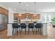 Modern kitchen with stainless steel appliances, black countertops, and bar seating at 2018 Stonecreek Dr, Woodstock, GA 30188