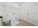 Bright laundry room featuring a utility sink, wire shelving, and a neutral-toned tile floor at 2018 Stonecreek Dr, Woodstock, GA 30188