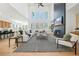 Expansive living room featuring large windows, open kitchen, and stylish decor at 2018 Stonecreek Dr, Woodstock, GA 30188