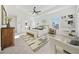 Bright main bedroom features a tray ceiling, neutral decor, sitting area, and doorway to an ensuite bathroom at 2018 Stonecreek Dr, Woodstock, GA 30188