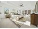 Bright main bedroom with large windows, tray ceiling, modern fan and rug, and stylish decor at 2018 Stonecreek Dr, Woodstock, GA 30188