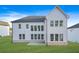 Rear view of a modern two-story home with white siding, a patio, and a spacious backyard at 2018 Stonecreek Dr, Woodstock, GA 30188