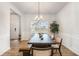 Bright dining room features hardwood floors, modern chandelier, and large window at 3133 Dowsing Ln, Powder Springs, GA 30127