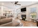 Bright living room featuring a fireplace, ceiling fan, and hardwood floors at 3133 Dowsing Ln, Powder Springs, GA 30127