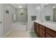 Well-lit bathroom features a soaking tub and a wooden vanity with ample storage at 3966 Covey Flush Sw Ct # 20, Smyrna, GA 30082