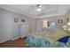 Bright bedroom offers a ceiling fan, hardwood floors, and ample storage with dressers and closets at 3966 Covey Flush Sw Ct # 20, Smyrna, GA 30082