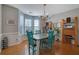 Charming dining room with hardwood floors, natural light, and a rustic wooden table with green chairs at 3966 Covey Flush Sw Ct # 20, Smyrna, GA 30082
