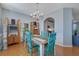 This bright dining area features a rustic wooden table with green chairs and hardwood flooring at 3966 Covey Flush Sw Ct # 20, Smyrna, GA 30082