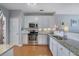 Bright kitchen with stainless steel appliances, granite countertops, and white cabinets at 3966 Covey Flush Sw Ct # 20, Smyrna, GA 30082