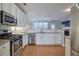 Well-lit kitchen with stainless steel appliances, white cabinets, and an open layout at 3966 Covey Flush Sw Ct # 20, Smyrna, GA 30082