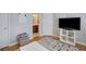 Comfortable living room with a TV, modern shelving, and a glimpse of the bathroom at 3966 Covey Flush Sw Ct # 20, Smyrna, GA 30082