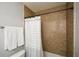 Bathroom with a beige tiled shower and a white and grey striped shower curtain at 125 N River Dr # F, Atlanta, GA 30350