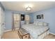 Comfortable bedroom with blue walls, a patterned bedspread, and two windows at 125 N River Dr # F, Atlanta, GA 30350