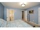 Bedroom with a view into the bathroom and hallway, with neutral carpet at 125 N River Dr # F, Atlanta, GA 30350