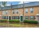 Charming brick townhomes with black shutters and colorful doors at 125 N River Dr # F, Atlanta, GA 30350